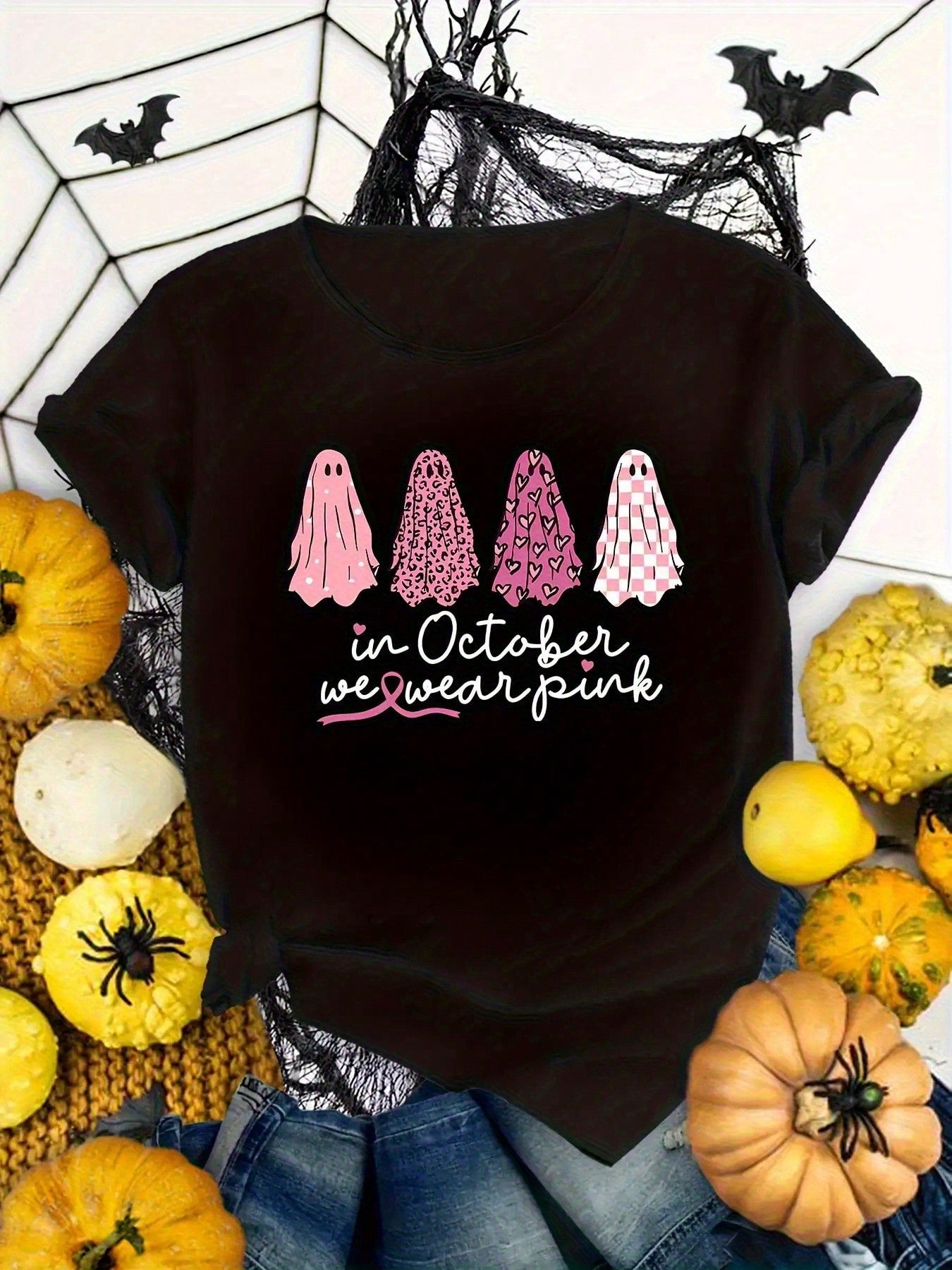 Halloween T-Shirt For Women Featuring A Design That Says 'In October We Wear Pink', Adorned With A Pink Ghost Motif black T-Shirt.